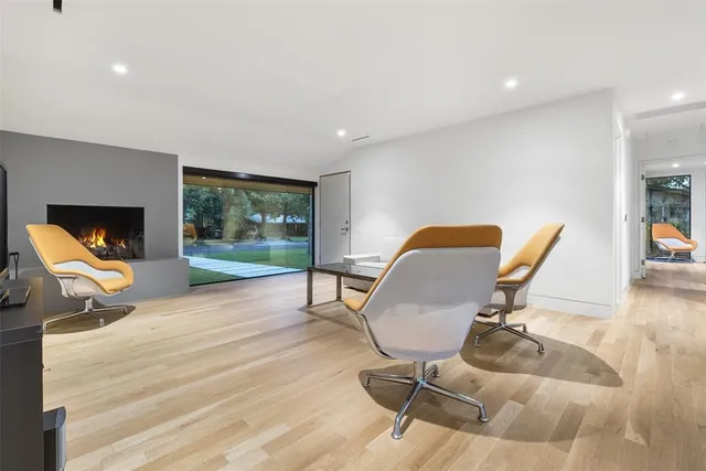 a workspace with furniture and a floor to ceiling window