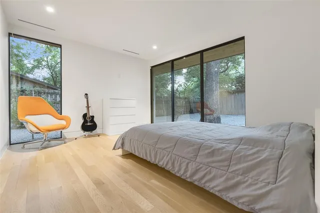 a bedroom with a bed chair and table in it
