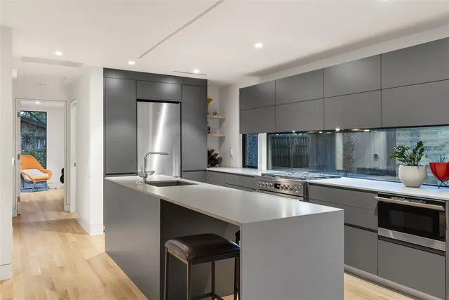 a kitchen with stainless steel appliances a sink stove and refrigerator