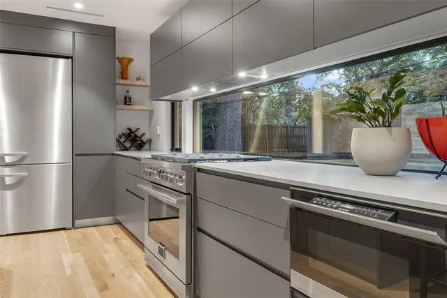 a kitchen with stainless steel appliances a sink stove and refrigerator