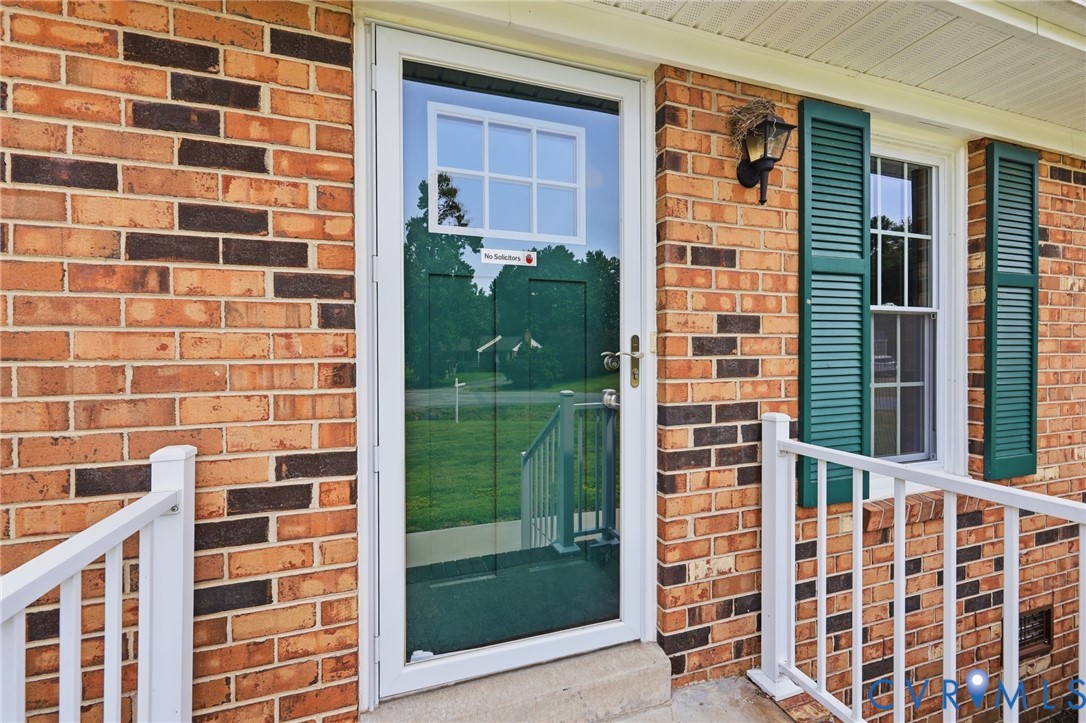 3221 Clintwood Road Midlothian, VA 23112 - Photo 7 of 46 Brick exterior with white railing, green louvered