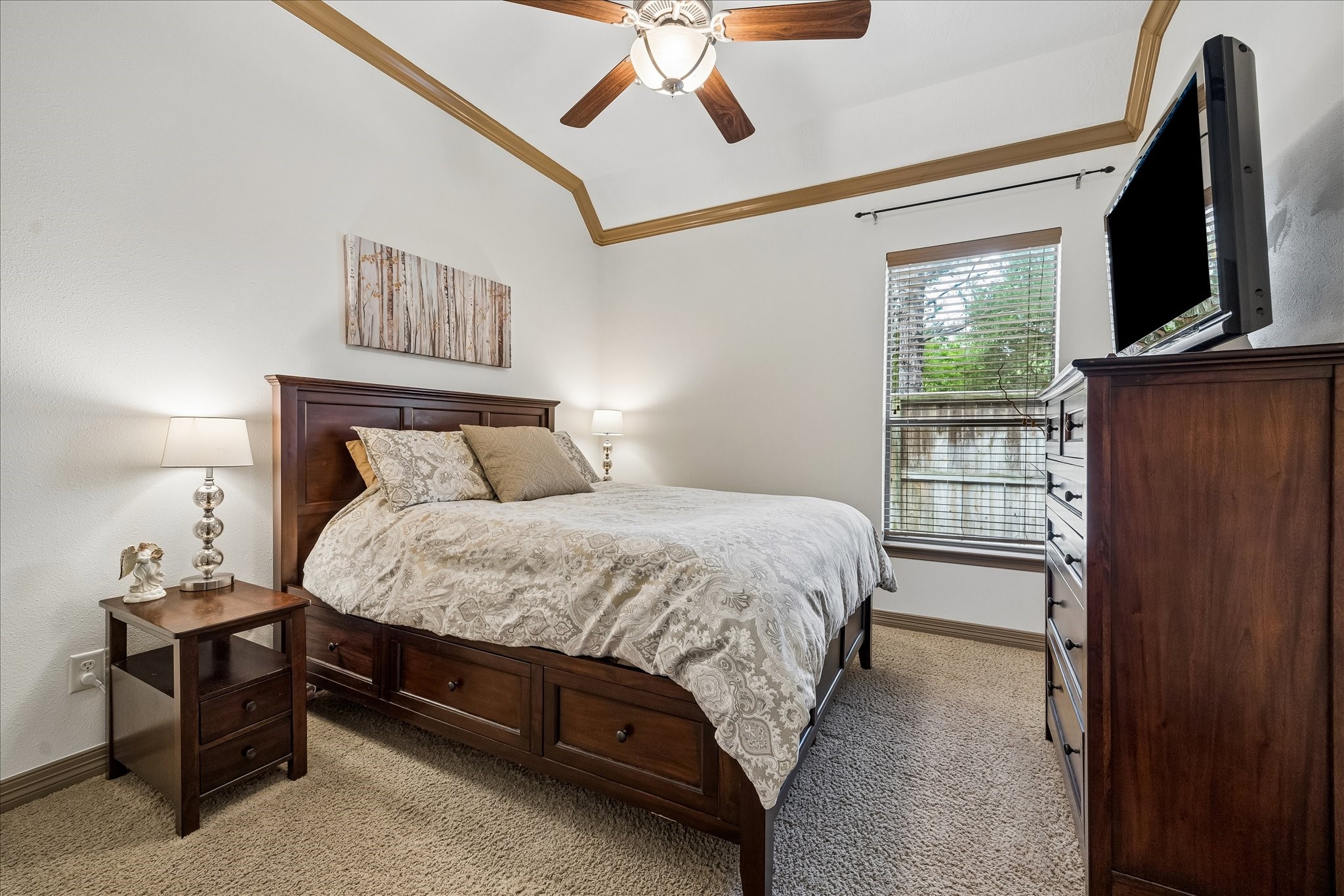 28211 Rippling Brook Lane Fulshear, TX 77441 - Photo 24 of 45 a bedroom with a bed and a flat tv screen on dresser
