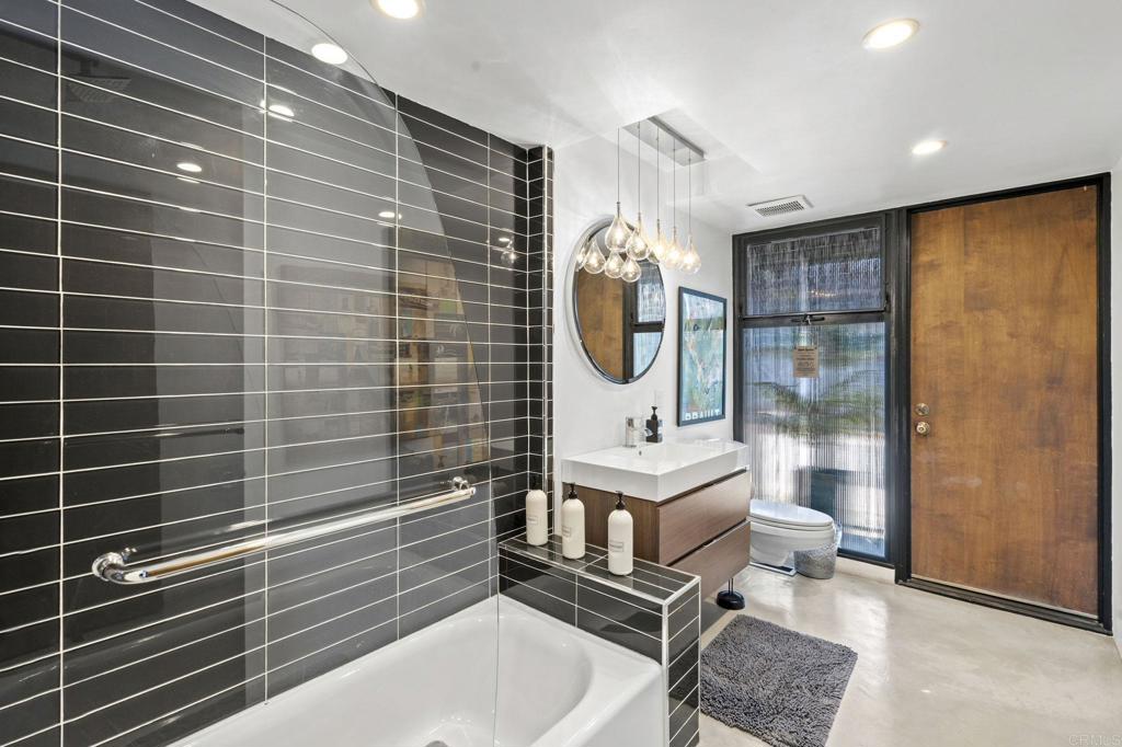 754 El Rancho Drive El Cajon, CA 92019 - Photo 17 of 55 a bathroom with a sink a mirror and shower
