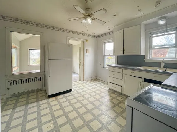 a kitchen with stainless steel appliances granite countertop a sink and a refrigerator
