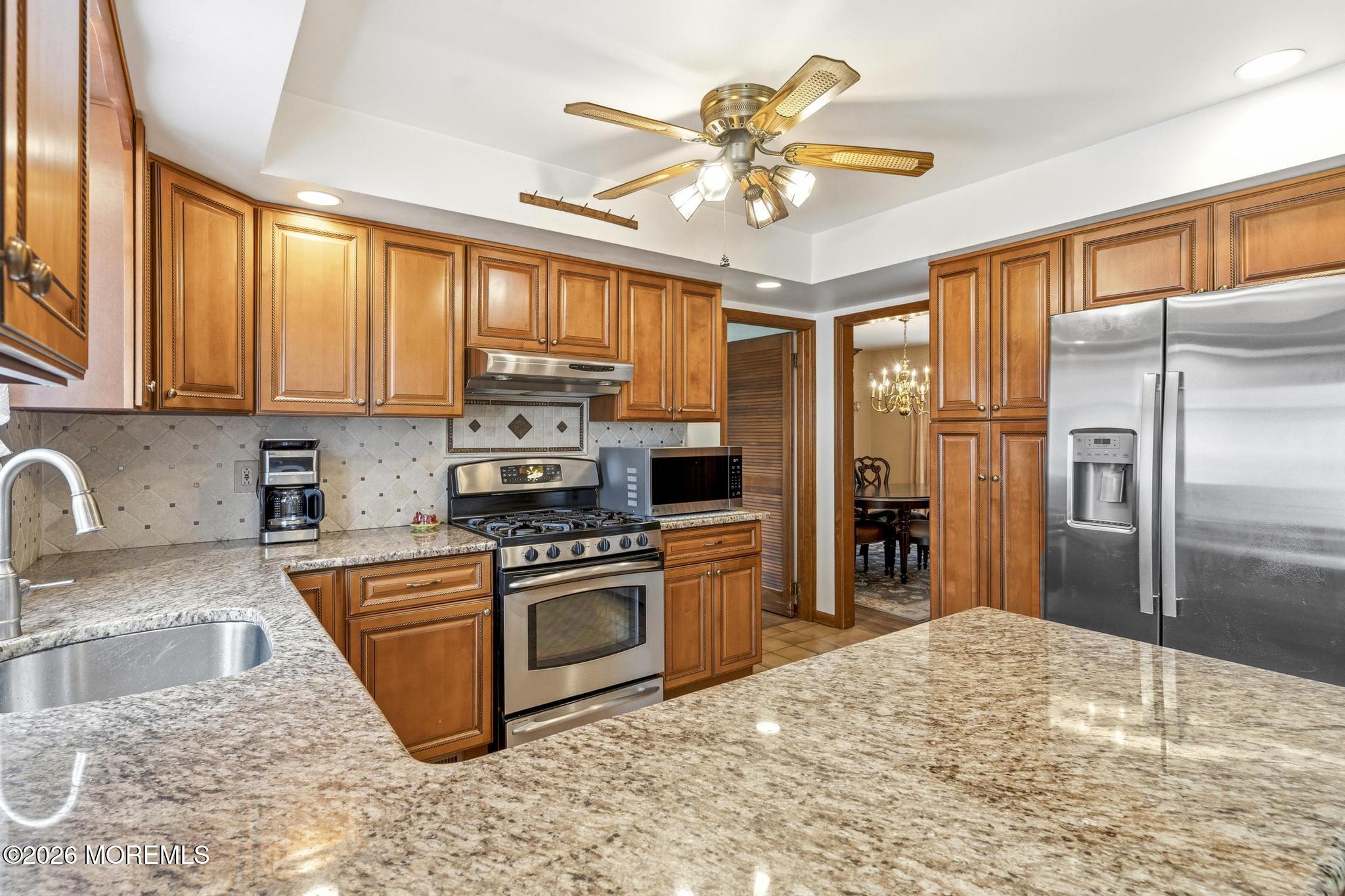 100 Sheldon Avenue Neptune Township, NJ 07753 - Photo 20 of 75 a kitchen with stainless steel appliances granite countertop a stove refrigerator sink and dishwasher with wooden floor