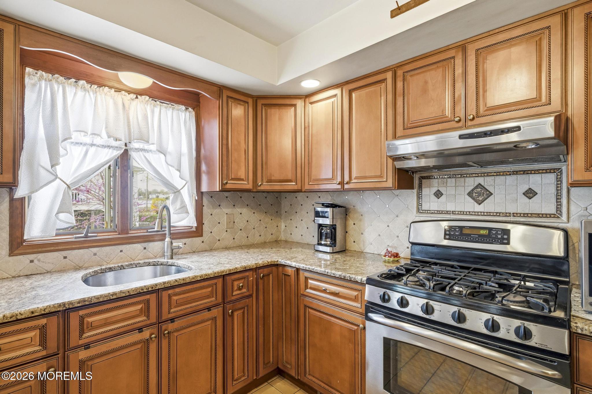 100 Sheldon Avenue Neptune Township, NJ 07753 - Photo 21 of 75 a kitchen with stainless steel appliances granite countertop a sink a stove and cabinets