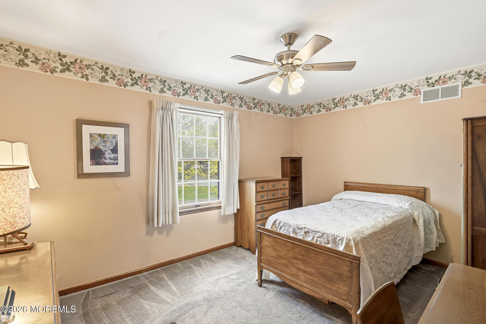 100 Sheldon Avenue Neptune Township, NJ 07753 - Photo 40 of 75 a bedroom with a bed and a chandelier