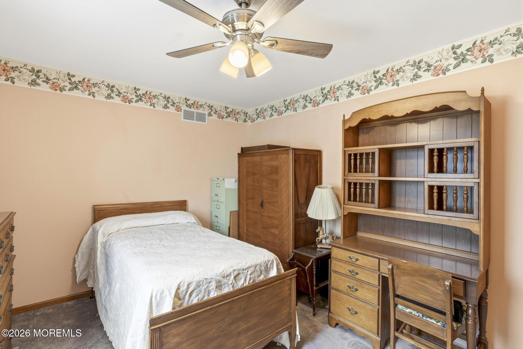 100 Sheldon Avenue Neptune Township, NJ 07753 - Photo 41 of 75 a bedroom with a bed and a chandelier