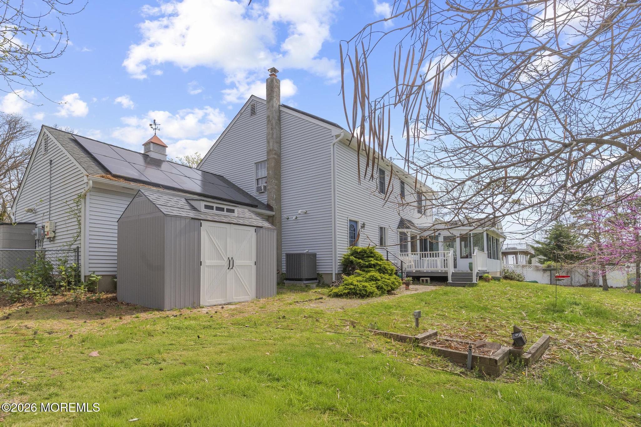 100 Sheldon Avenue Neptune Township, NJ 07753 - Photo 51 of 75 a view of a white house next to a yard with big trees
