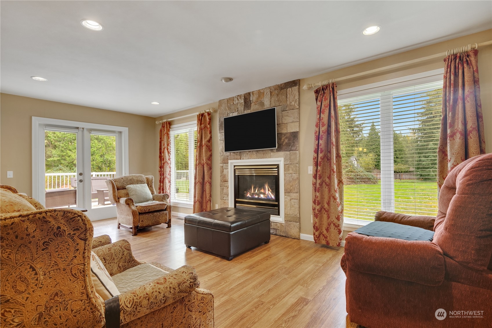Undisclosed Address Bothell, WA 98021 - Photo 3 of 16 a living room with furniture a flat screen tv and a fireplace