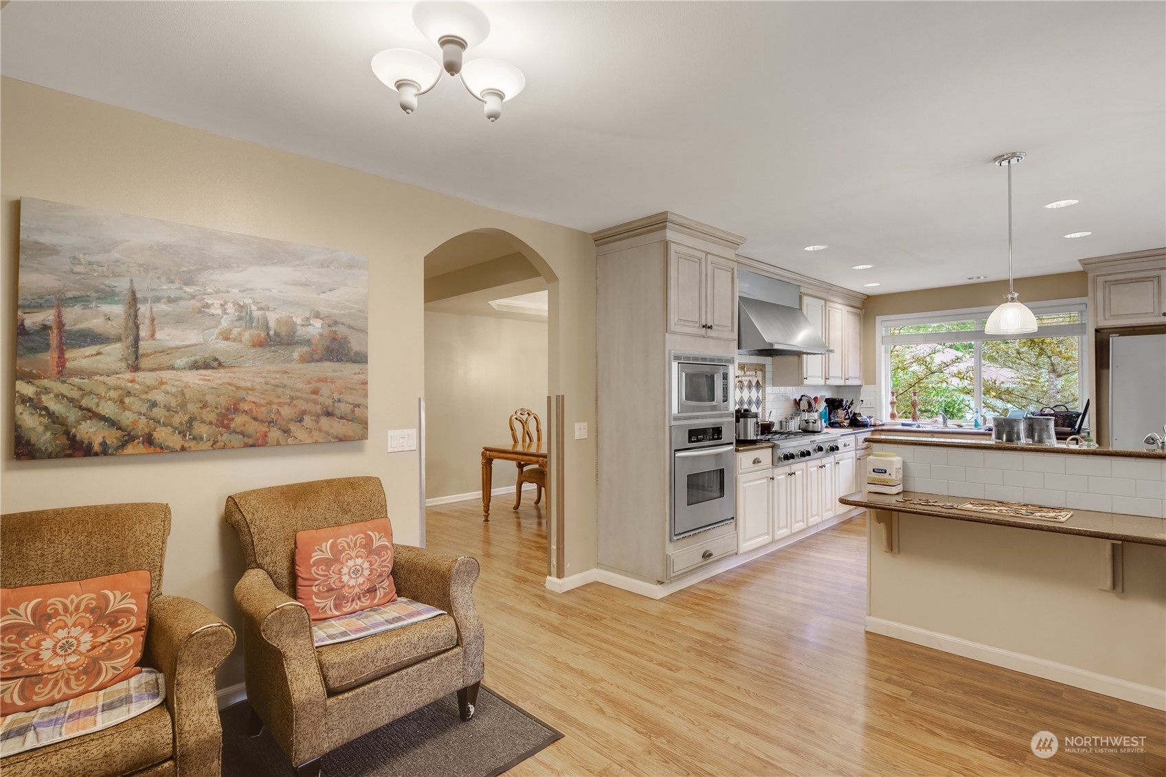 Undisclosed Address Bothell, WA 98021 - Photo 4 of 16 a large living room with stainless steel appliances kitchen island granite countertop furniture and a large window