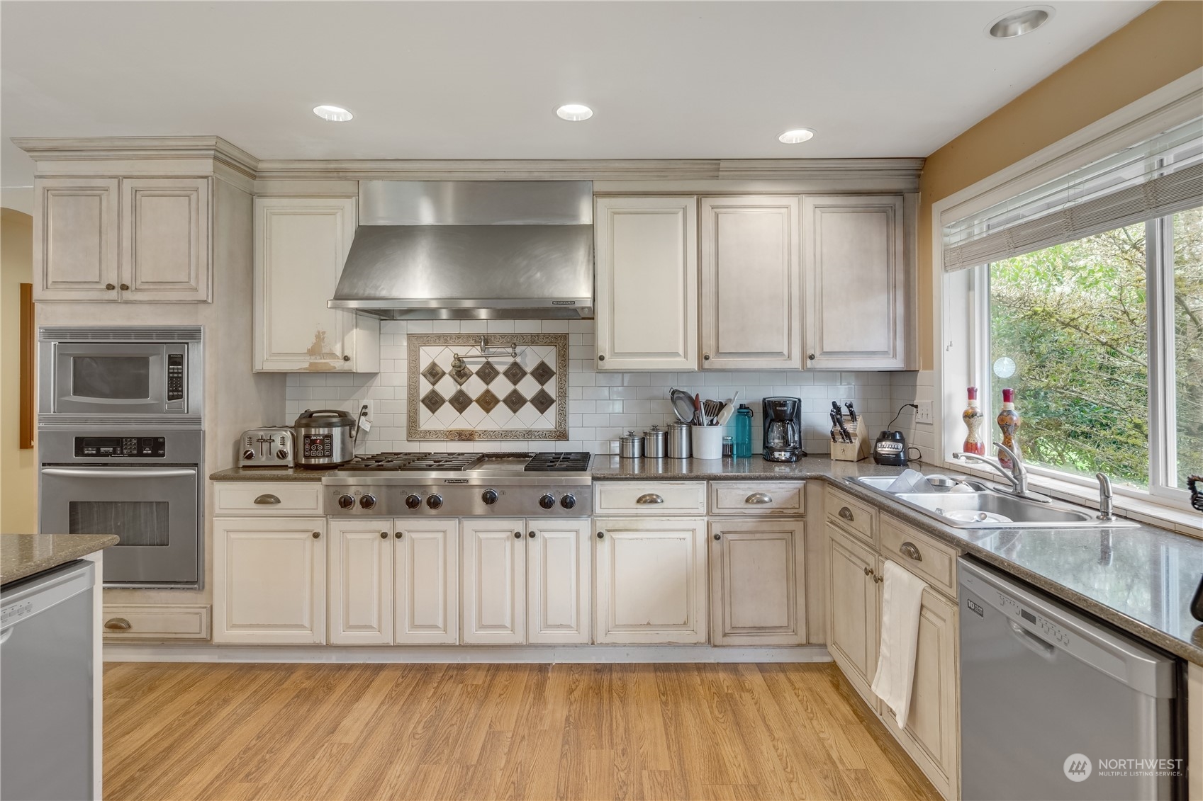 Undisclosed Address Bothell, WA 98021 - Photo 6 of 16 a kitchen with stainless steel appliances granite countertop a stove a sink and white cabinets