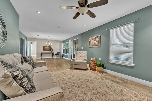 a living room with furniture and wooden floor
