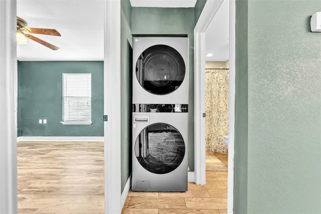 a view of a bedroom with washer and dryer