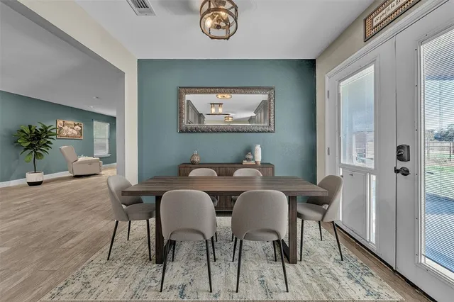a view of a dining room with furniture and wooden floor