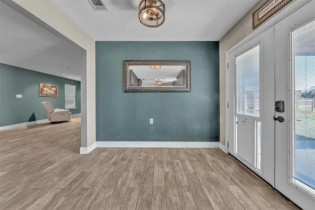 a view of a hallway with wooden floor