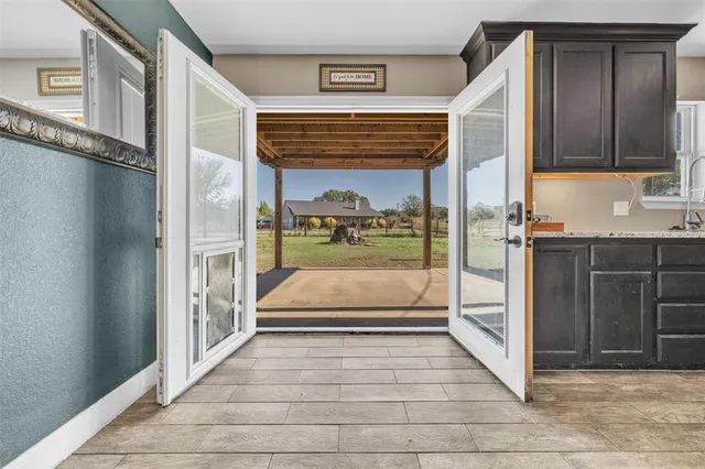 a large space with a window and wooden cabinets