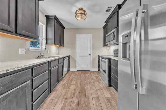 a spacious bedroom with a bed a couch and window