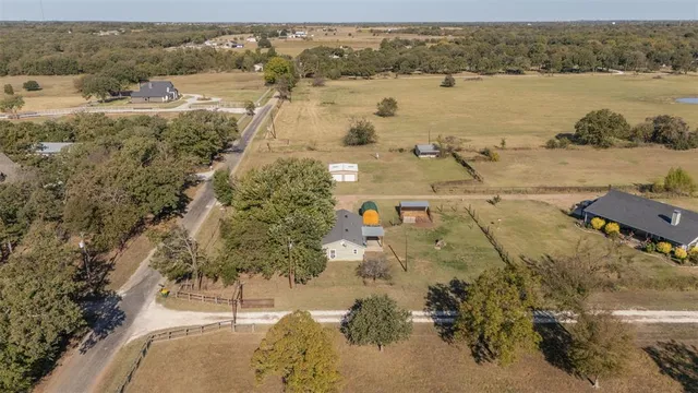 a view of a backyard with large trees