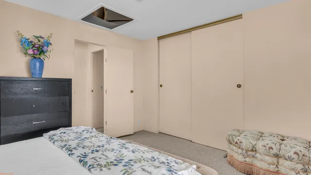 a bedroom with a bed and a potted plant