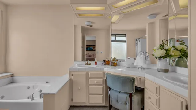 a bathroom with a bathtub sink vanity and mirror