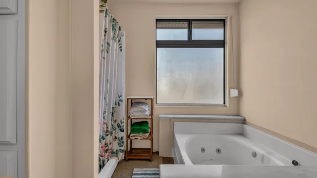 a bathroom with a bathtub with a window