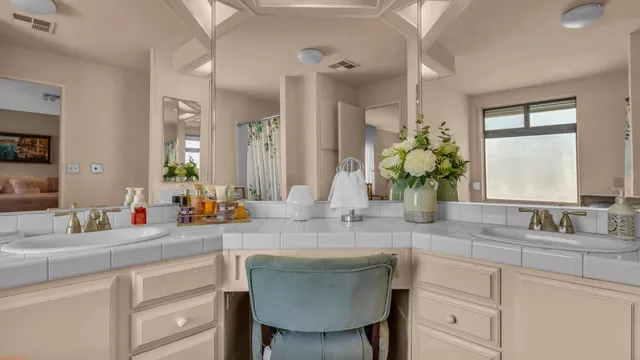 a bathroom with a sink double vanity and a mirror