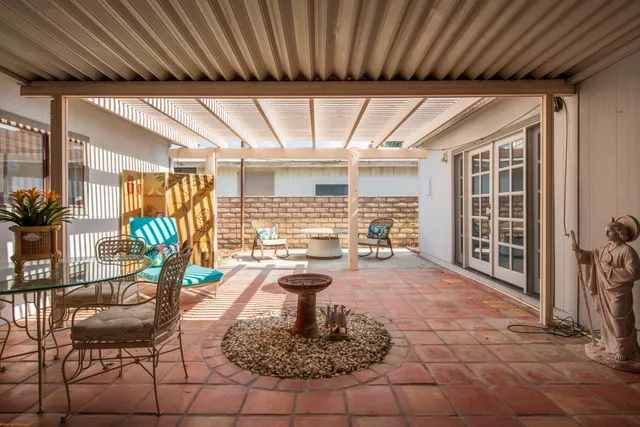 a living room with furniture a flat screen tv and a table