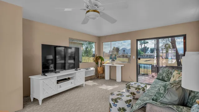 a living room with furniture and flat screen tv