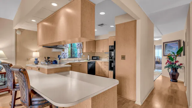 a large kitchen with a table and chairs