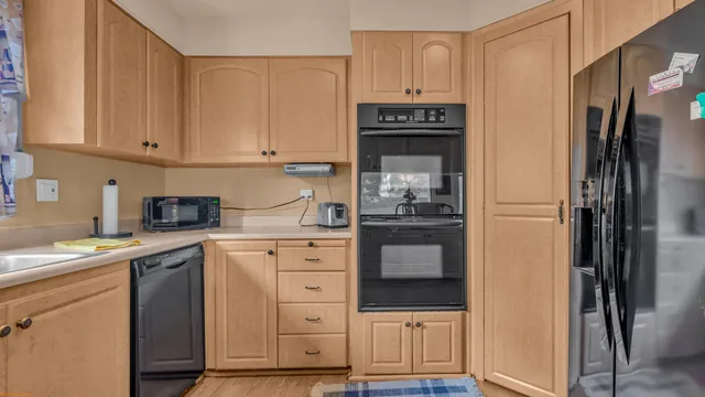 a kitchen with stainless steel appliances granite countertop a refrigerator sink and cabinets