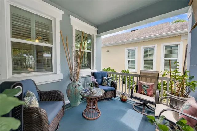 a view of a dining room with furniture a chandelier and wooden floor