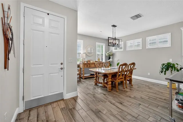a view of a dining room with furniture window and wooden floor
