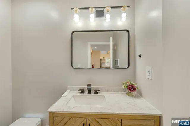 a bathroom with a toilet sink and mirror