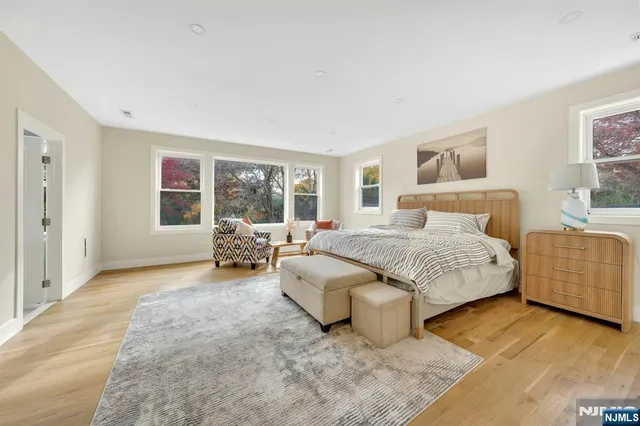 a spacious bedroom with a bed and a large window