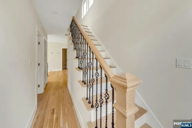 a view of entryway and hall with wooden floor
