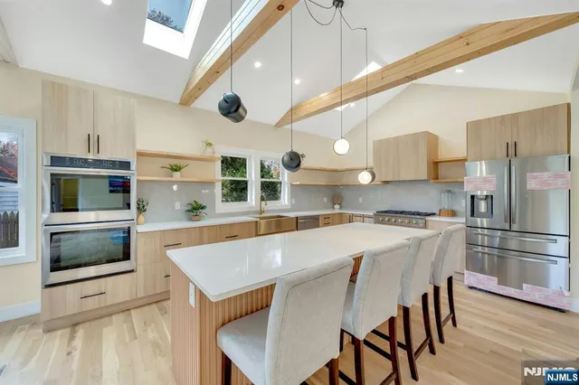 a kitchen with a table chairs microwave and cabinets