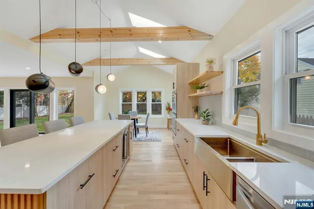 a large kitchen with stainless steel appliances a large counter space