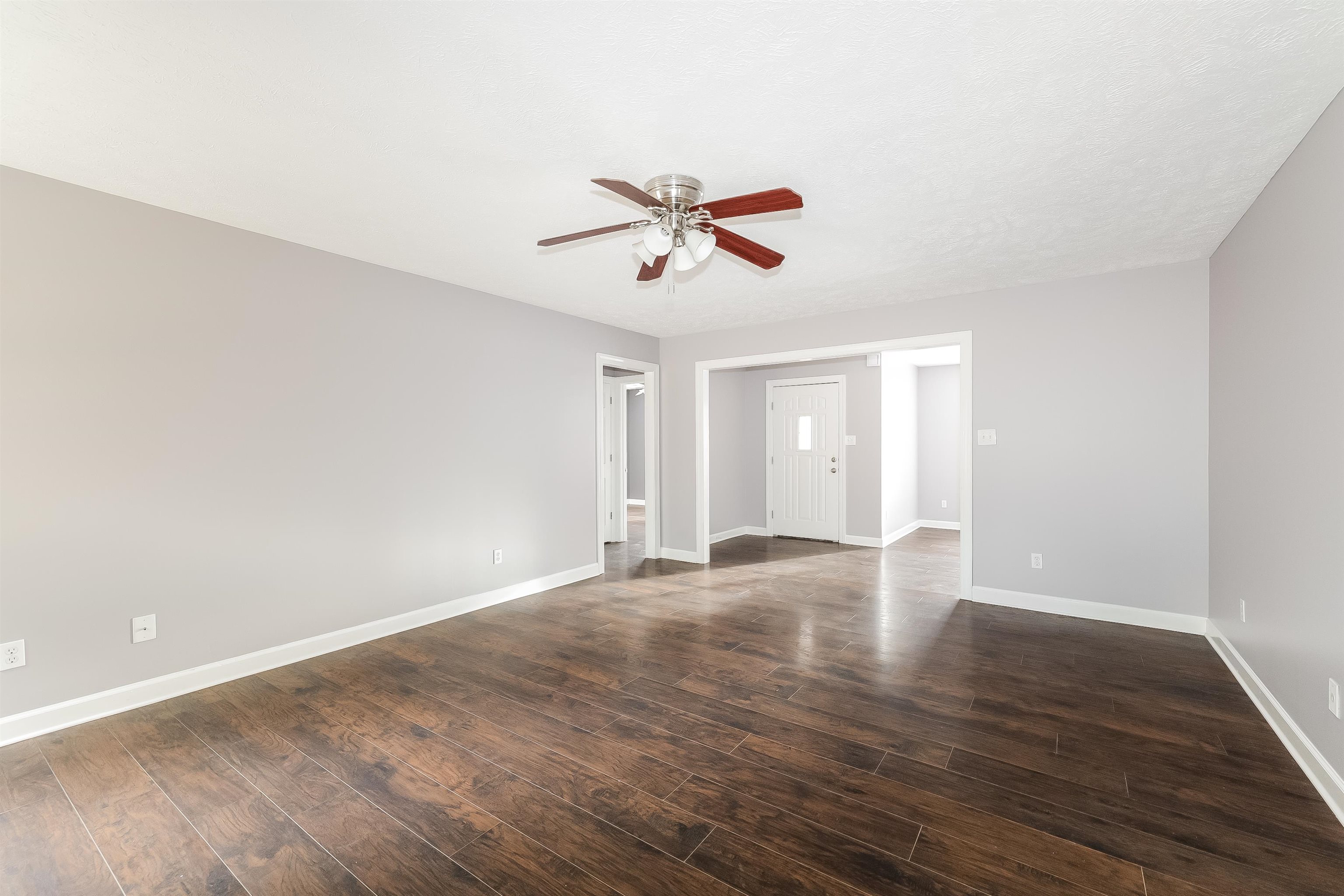 97 Jadewood Drive Jackson, TN 38305 - Photo 3 of 16 an empty room with wooden floor and windows