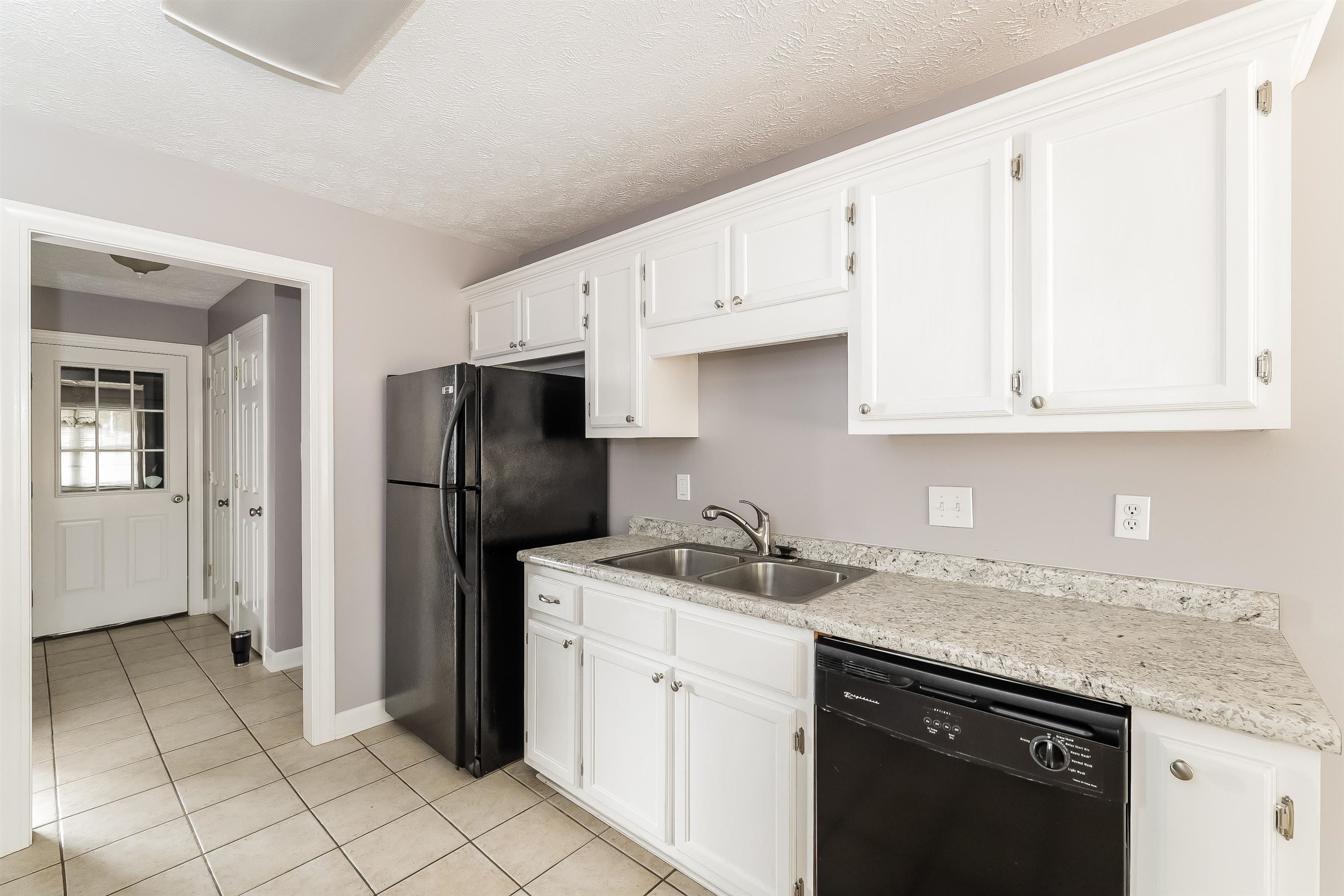 97 Jadewood Drive Jackson, TN 38305 - Photo 7 of 16 a kitchen with stainless steel appliances granite countertop a sink stove and refrigerator