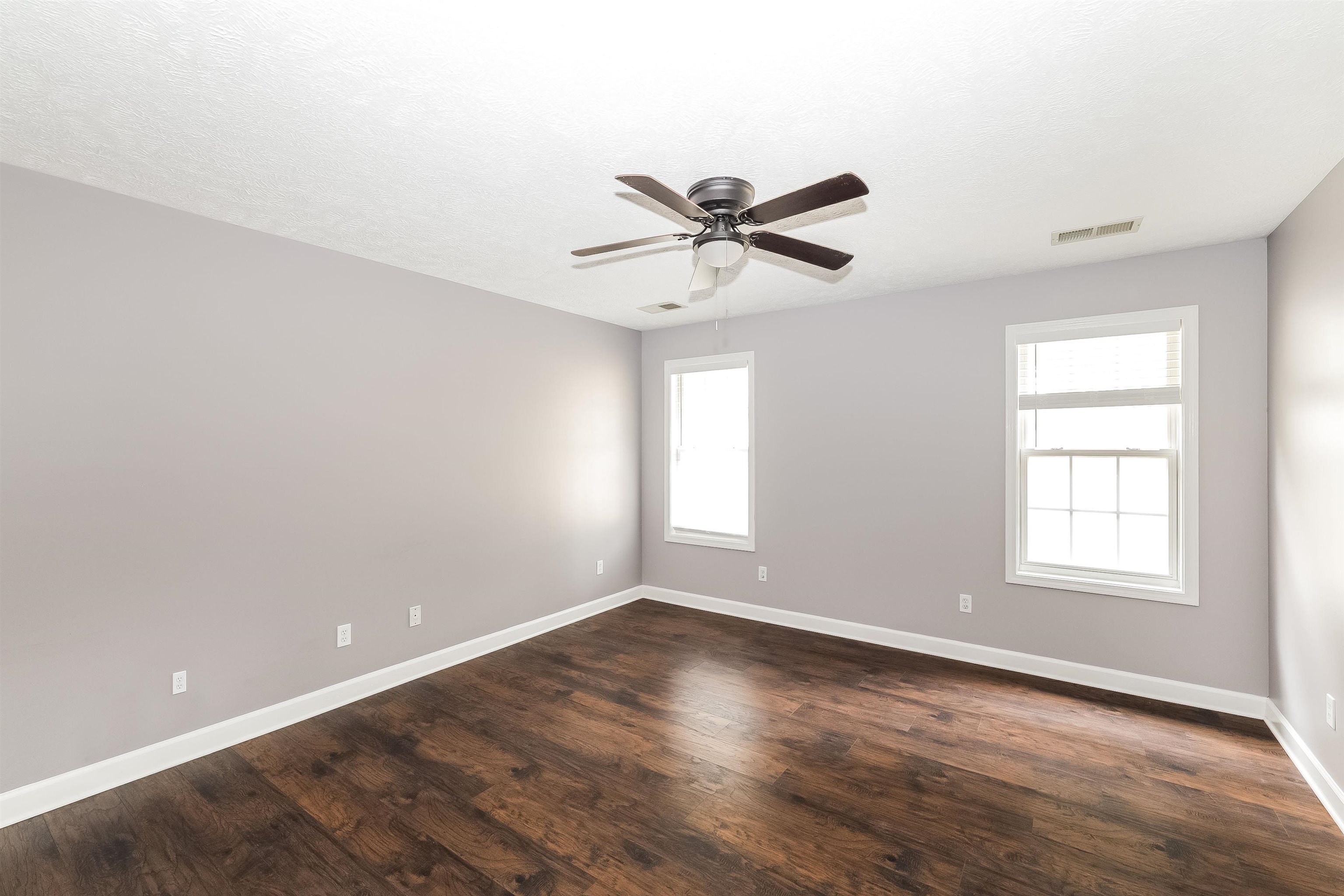 97 Jadewood Drive Jackson, TN 38305 - Photo 8 of 16 an empty room with wooden floor and windows