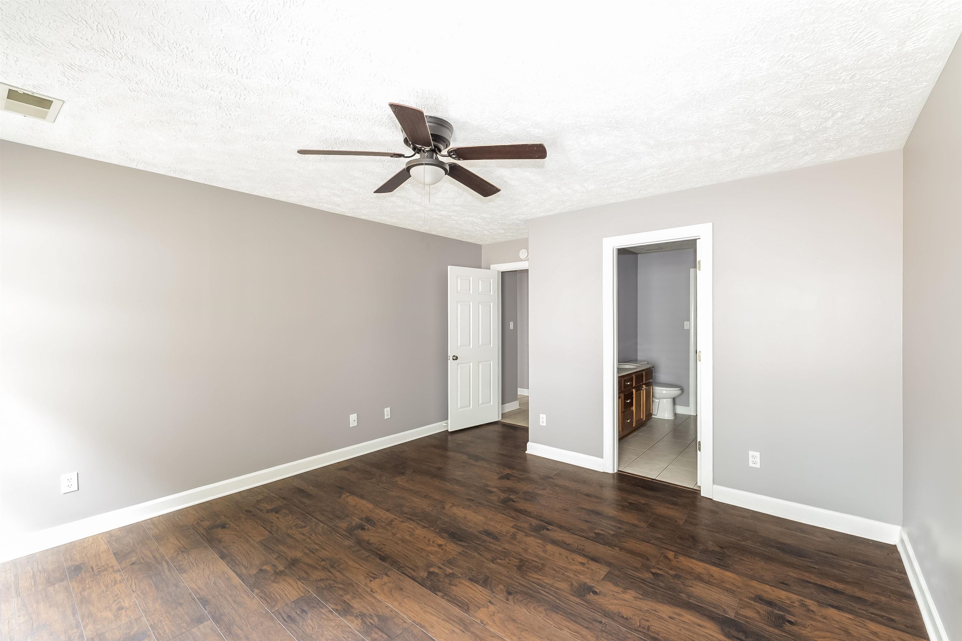 97 Jadewood Drive Jackson, TN 38305 - Photo 9 of 16 a view of empty room with wooden floor and fan