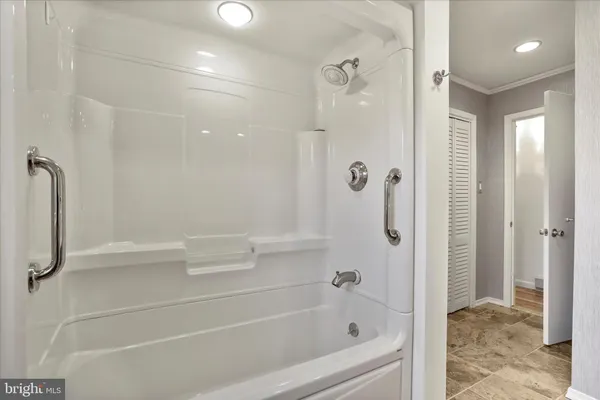 a bathroom with a bathtub and a shower