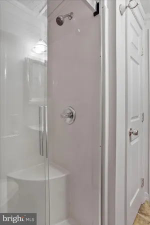 a bathroom with a glass shower door