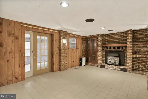 a view of an empty room with a fireplace and a window