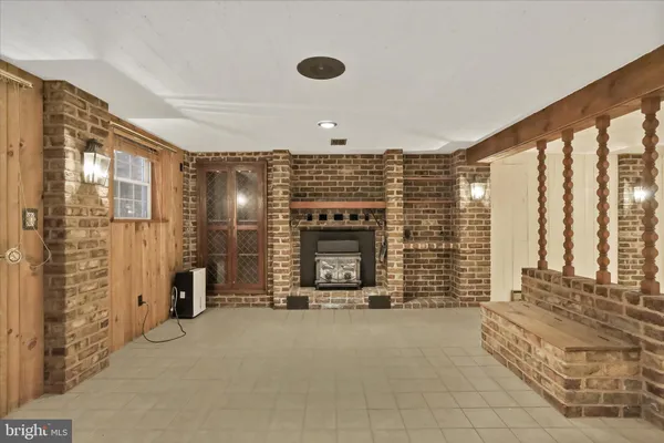 a view of hall with floor to ceiling window and a fireplace