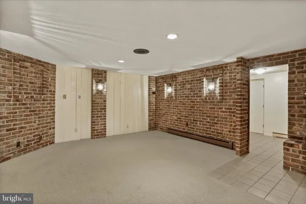 a view of an empty room with brick walls