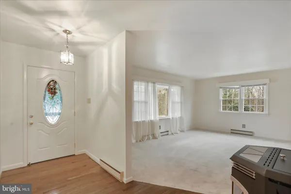 an empty room with windows and chandelier