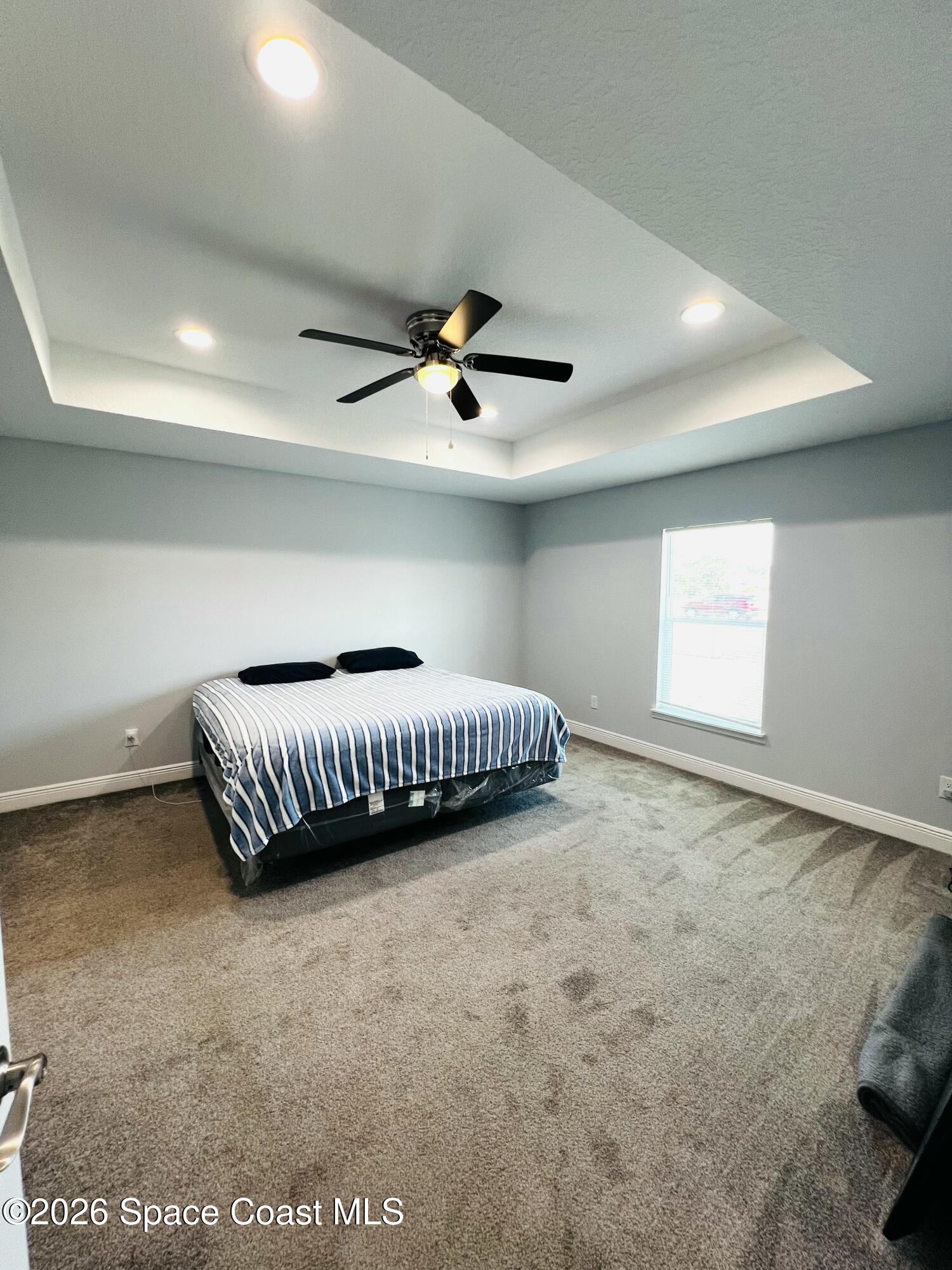 379 Wilton Avenue Southwest Melbourne, FL 32908 - Photo 17 of 26 a living room with a bed furniture and a ceiling fan