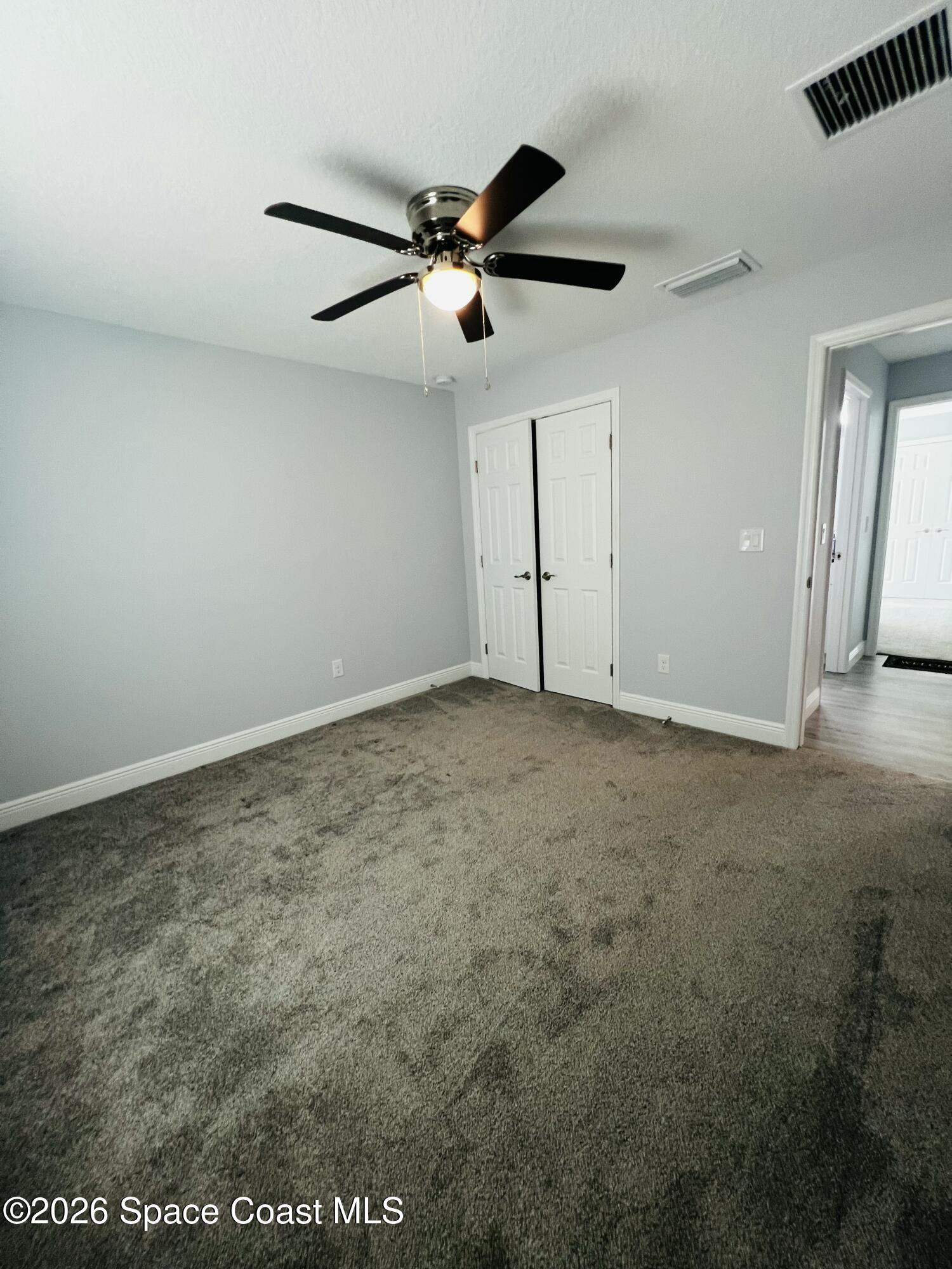 379 Wilton Avenue Southwest Melbourne, FL 32908 - Photo 18 of 26 an empty room with a ceiling fan and a window
